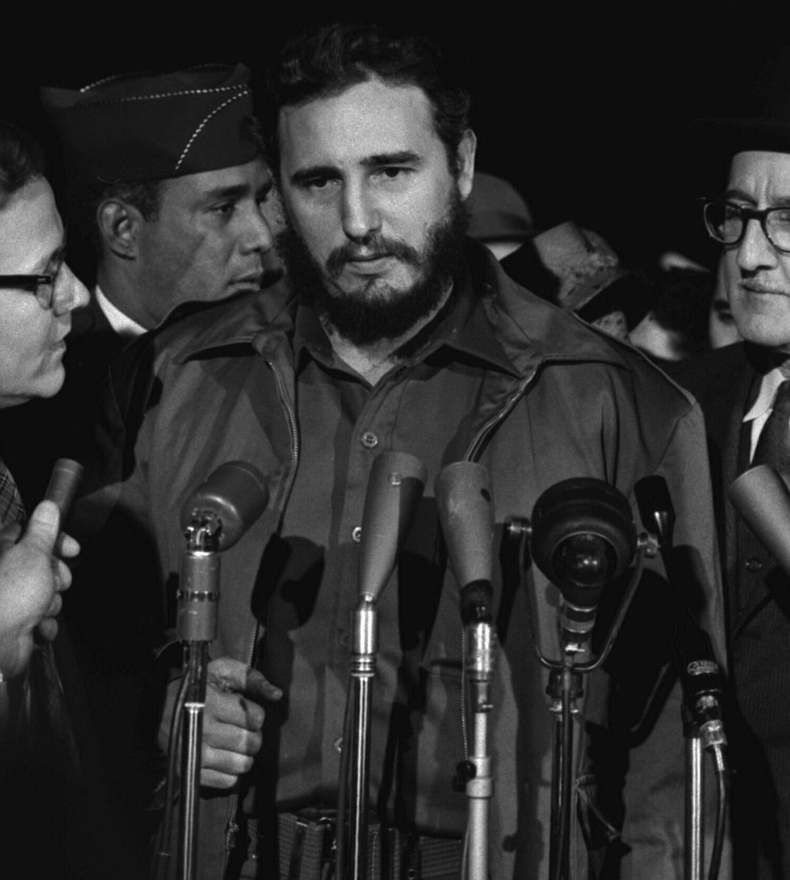 a man standing in front of a bunch of microphones, a portrait, by Robert Jacobsen, che guevara, press photos, square, during the night