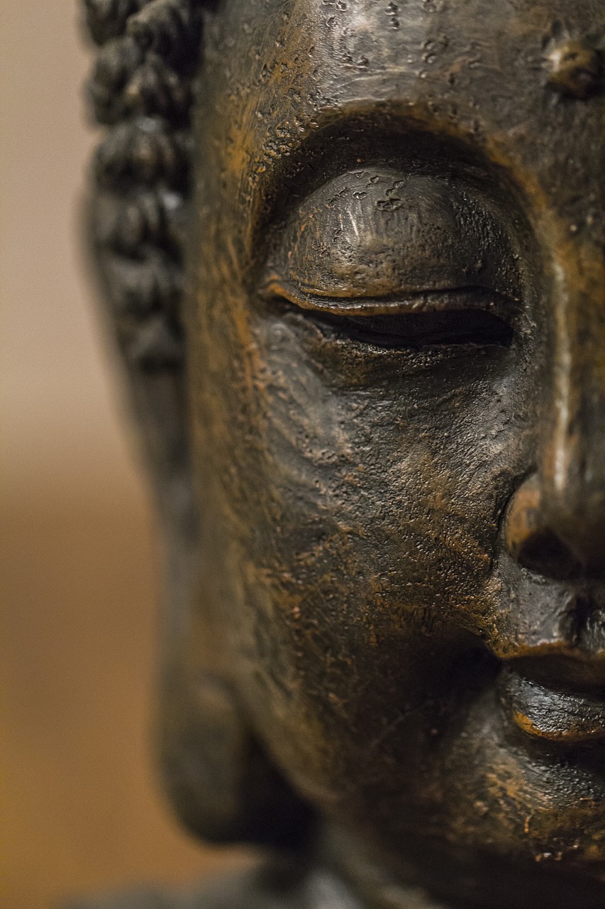 a close up of a statue of a person's face, a bronze sculpture, unsplash, cloisonnism, zen atmosphere, slightly turned to the right, highly detailed shot, looking towards camera