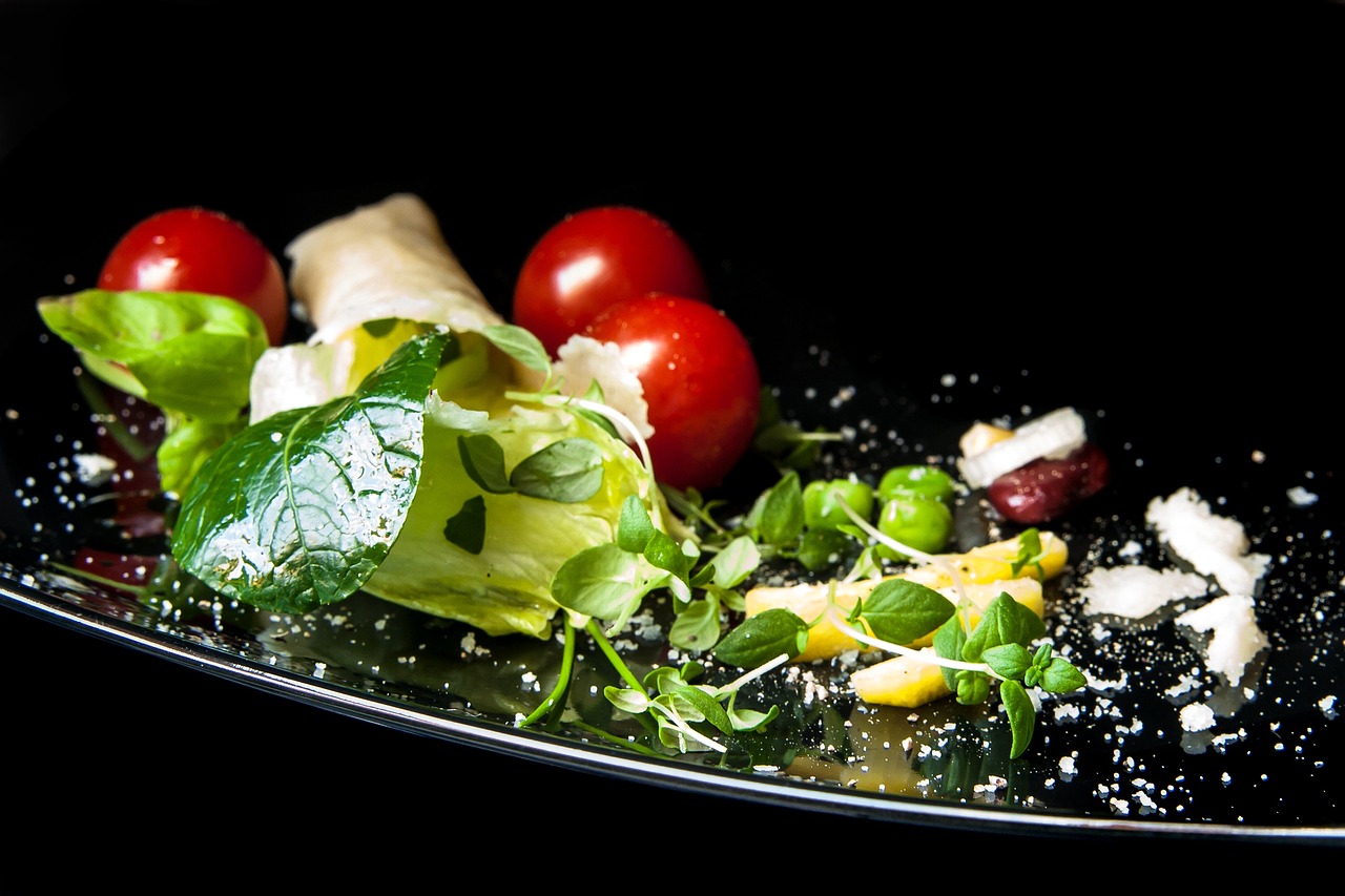 a close up of a plate of food on a table, a picture, shutterstock, romanticism, on black background, salad, cheeses, vegetable foliage