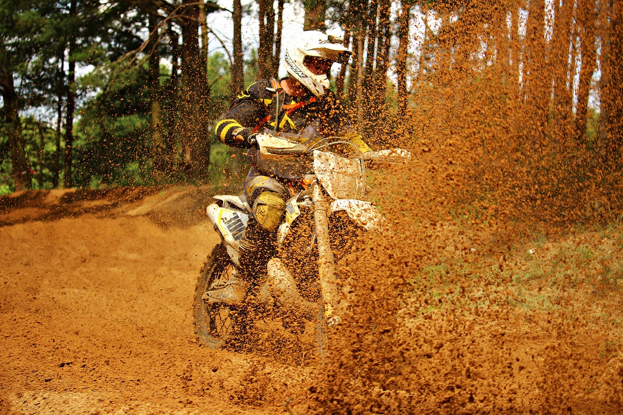 a man riding on the back of a dirt bike, flickr, photorealism, sand particles, mustard, colors white!!, taken with canon eos 5 d