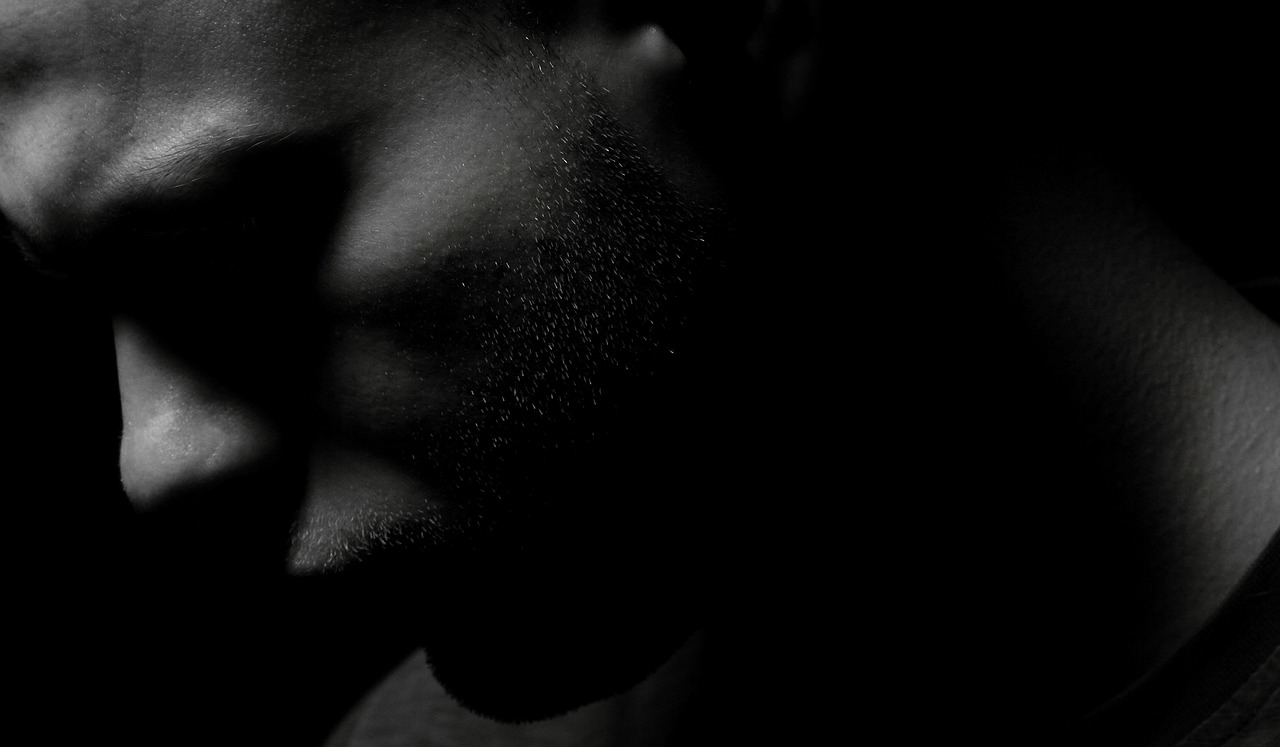 a black and white photo of a man in the dark, a black and white photo, pexels, realism, shadow of beard, african american, neck zoomed in from lips down, people's silhouettes close up