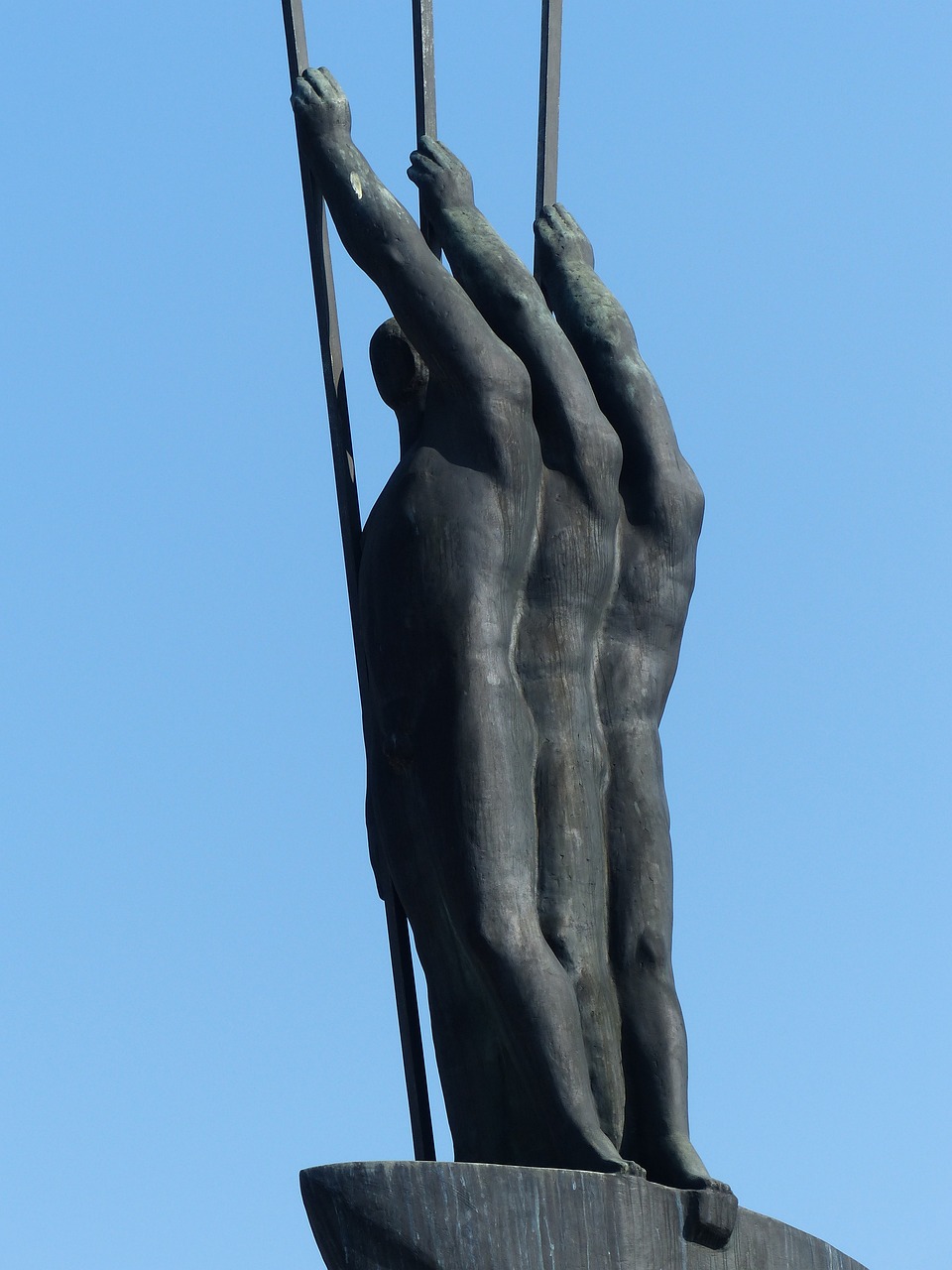 a statue in front of a clear blue sky, inspired by Sir Jacob Epstein, his arms and legs are hanging, hands of men, three masts, ultrafine detail ”