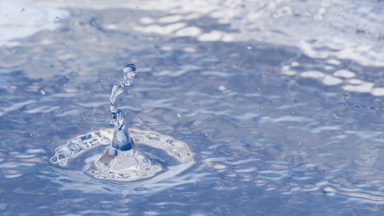 a water drop falling into a pool of water, a digital rendering, shutterstock, water pipe, medium close-up shot, on a sunny day, miniature product photo