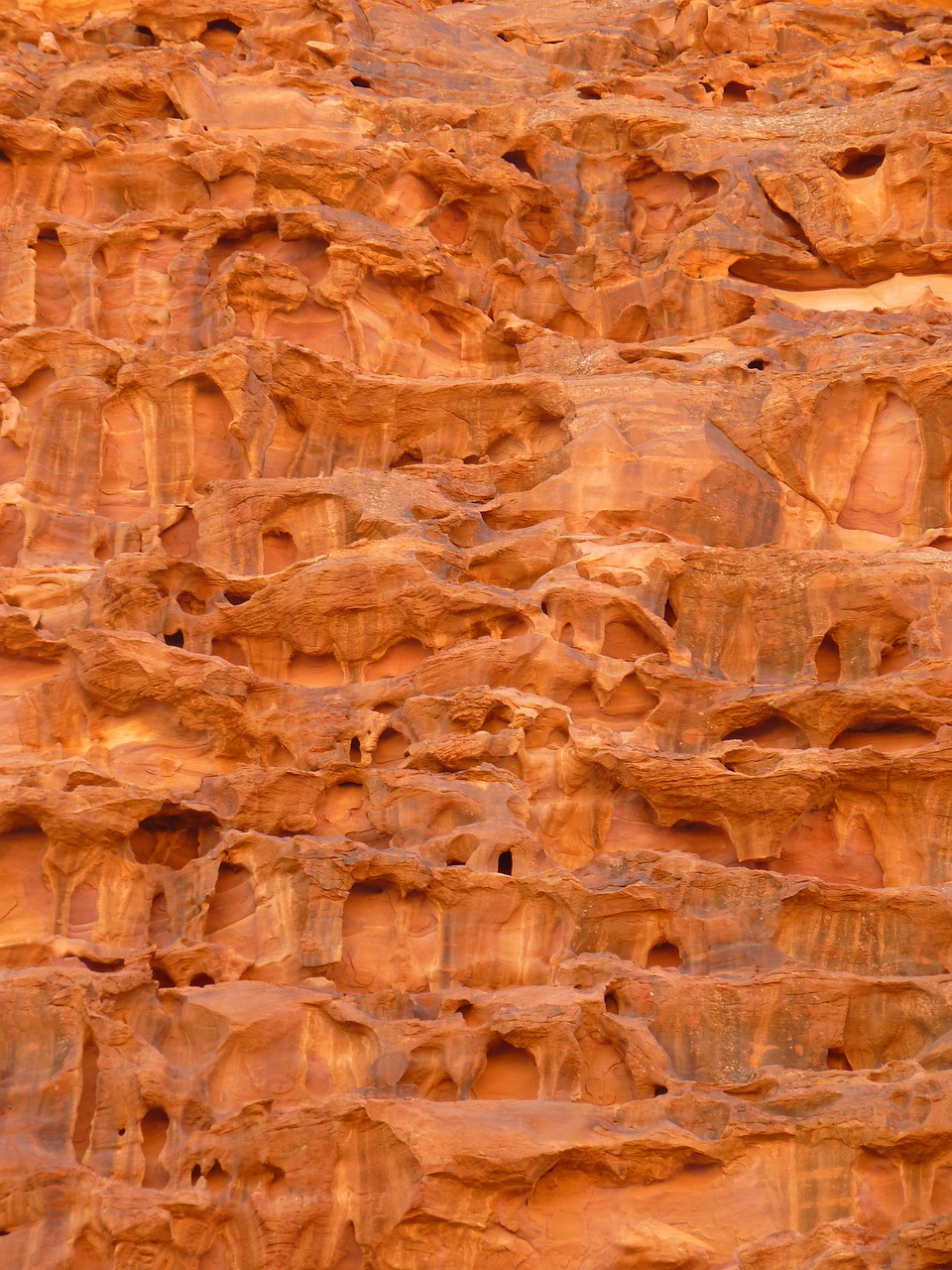 a close up of a rock wall with holes in it, by Linda Sutton, wadi rum, impressive detail : 7, flaming mountain, grain”