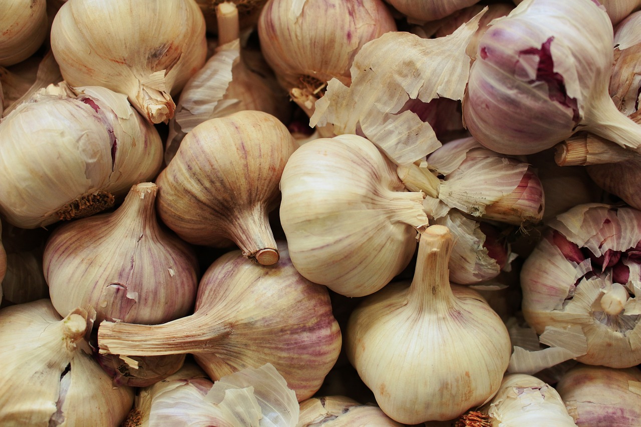 a pile of garlic sitting on top of a table, a picture, by Harold von Schmidt, pixabay, hurufiyya, stock photo, maroon, pale pointed ears, chicago