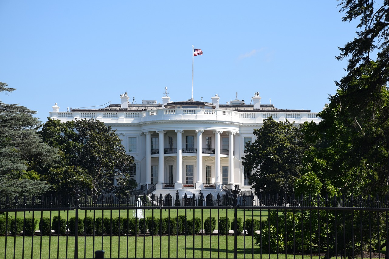 a large white building with a flag on top of it, a picture, by Whitney Sherman, shutterstock, presidential, a middle-shot from front, not blurry, ham