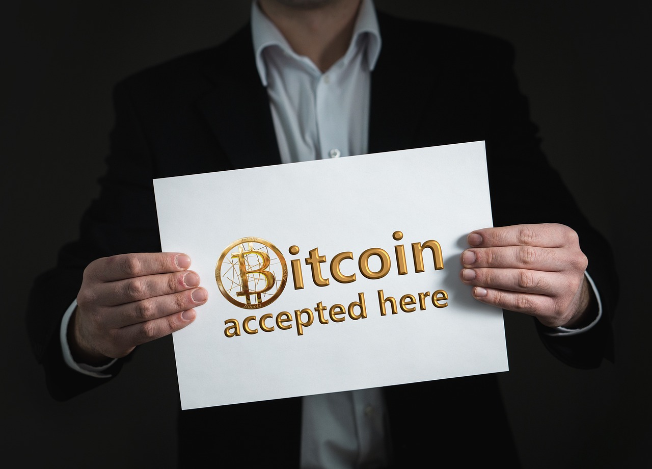 a man holding a sign that says bitcoin accepted here, a photo, pixabay, renaissance, high res, golden accents, overhead shot, signed