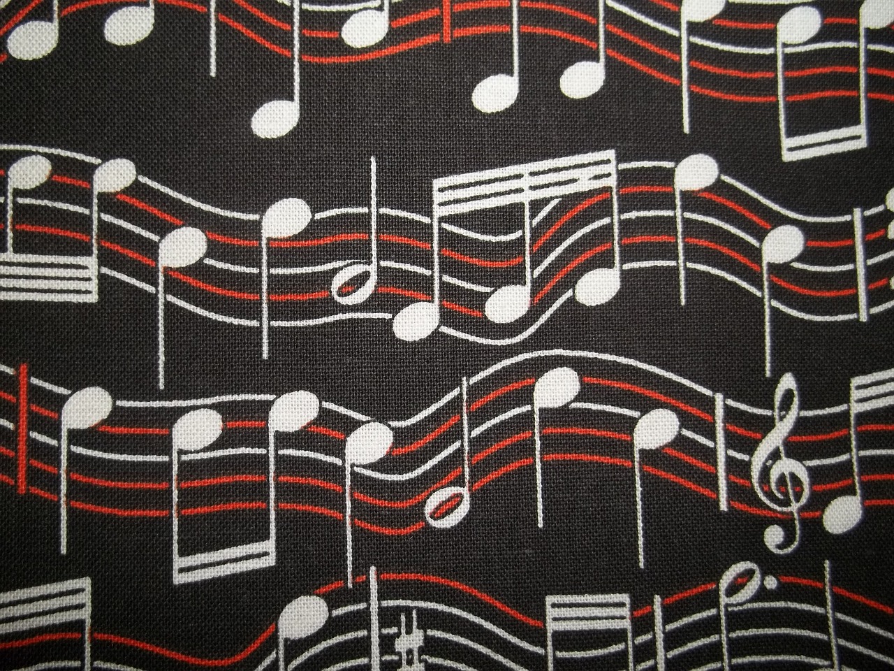 a close up of a tie with musical notes on it, inspired by Kawai Gyokudō, tumblr, sōsaku hanga, dark background ”, red and white and black colors, grain”
