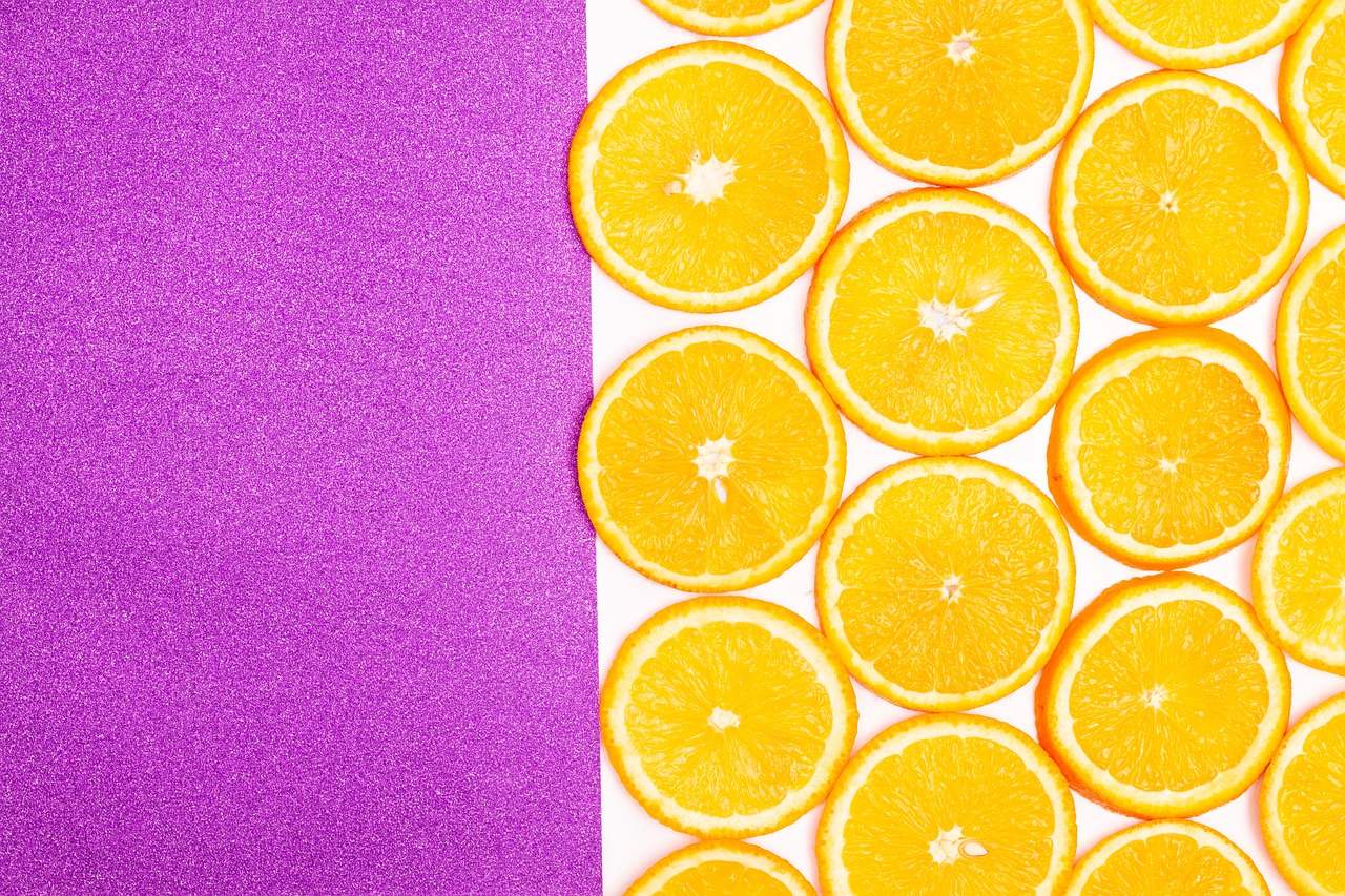 a close up of orange slices on a purple background, a stock photo, inspired by Christo, full of colour 8-w 1024, white background, patterned background, sun is shining