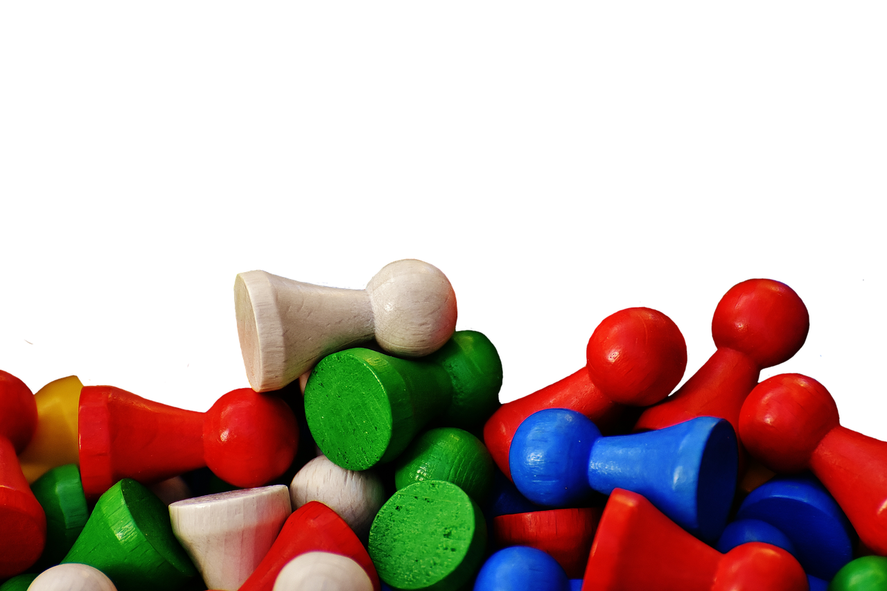 a pile of colorful pegs sitting on top of each other, a tilt shift photo, against a deep black background, wooden banks, green blue red colors, cups and balls