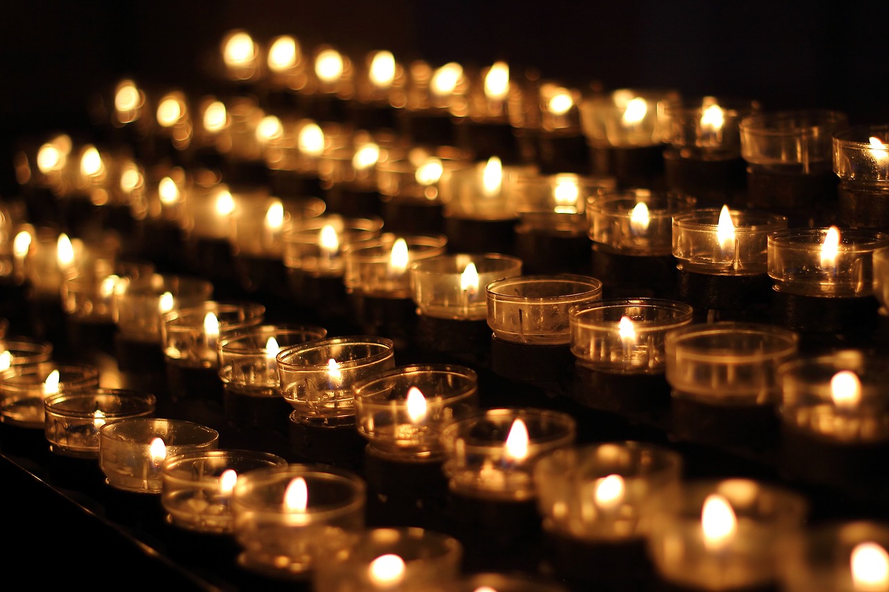 a group of lit candles sitting on top of a table, a photo, lines of lights, in a row, immaculately detailed, high quality image”