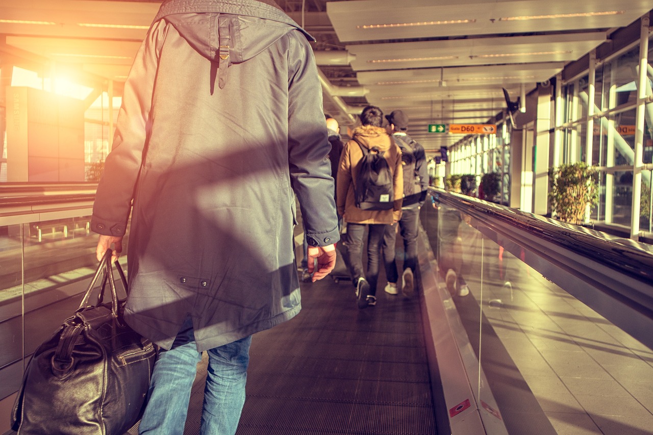 a group of people walking down an escalator, a picture, by Jakob Gauermann, shutterstock, wearing dirty travelling clothes, in suitcase, sundown, stock photo