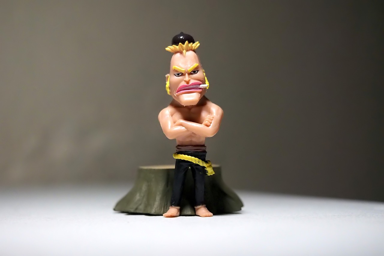 a close up of a figurine of a man, inspired by Tōshūsai Sharaku, unsplash, technoviking male with no shirt, clash royal style characters, 35 mm product photo”, angry frown
