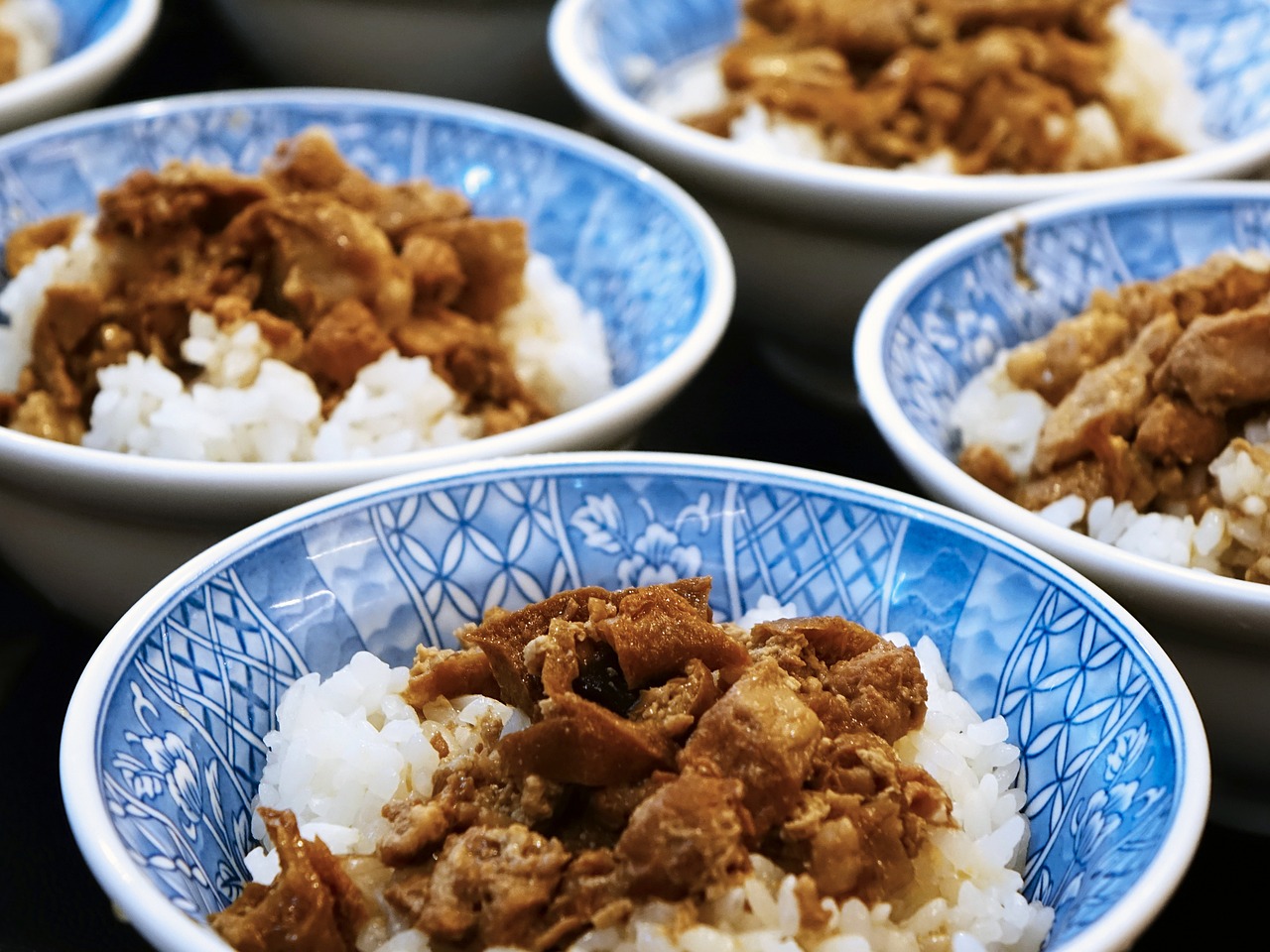 a close up of bowls of food on a table, a picture, flickr, mingei, pork, high res photo, blue, yukito kishiro