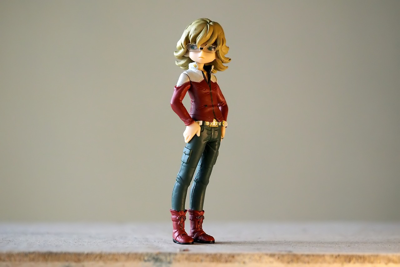 a close up of a figurine of a woman, a picture, inspired by Yumihiko Amano, red shirt brown pants, short curly blonde haired girl, full body character concept, ( ( ( wearing jeans ) ) )