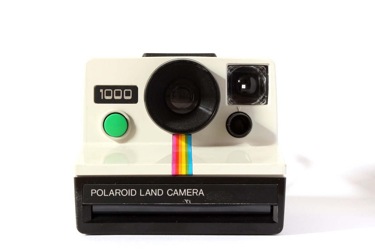 a polaroid land camera sitting on top of a table, pop art, iso 1000, on a white background, my pov, lama