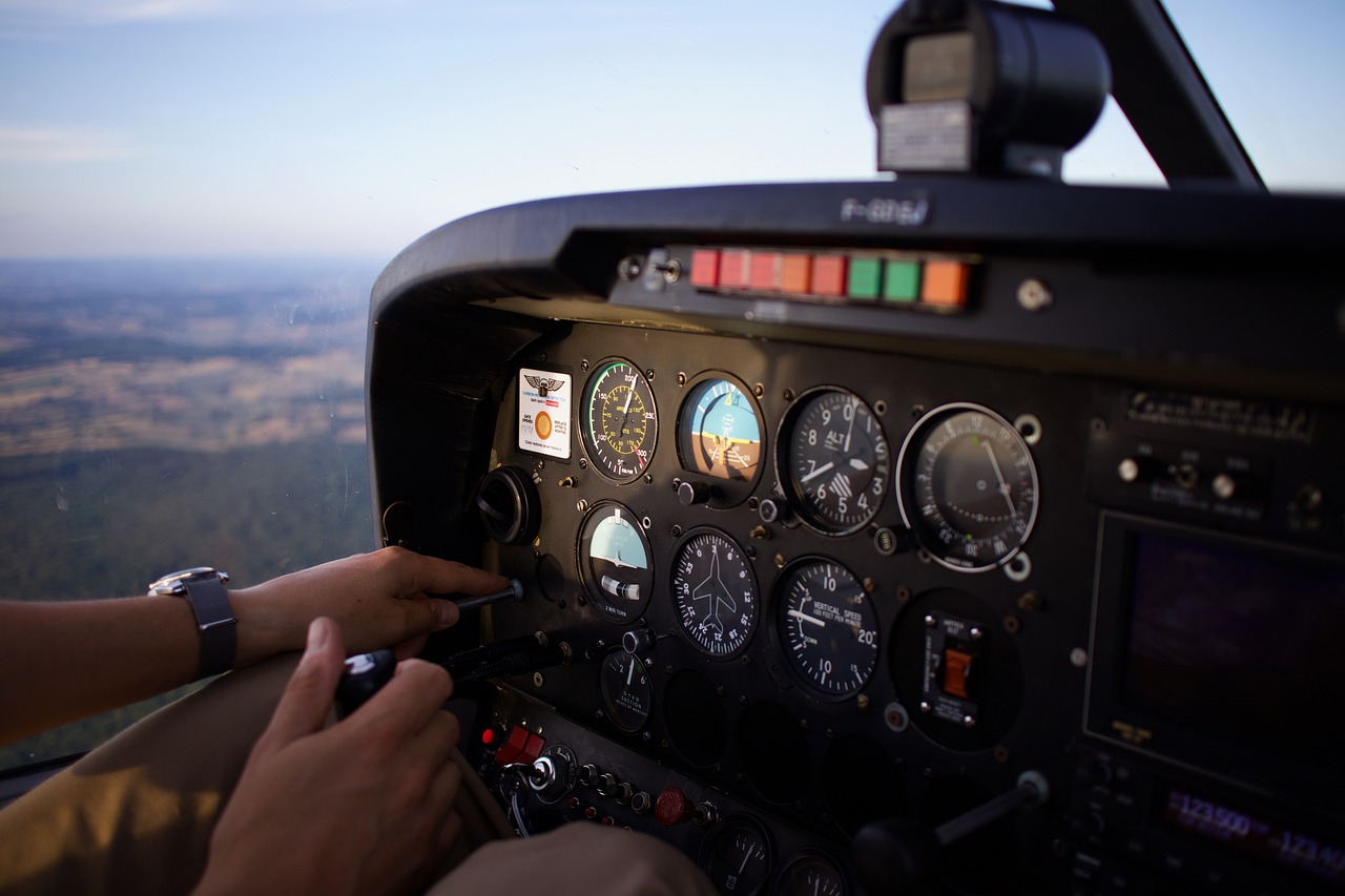 a man that is sitting in the cockpit of a plane, a picture, pexels, dials, close up shot from the top, istock, cessna