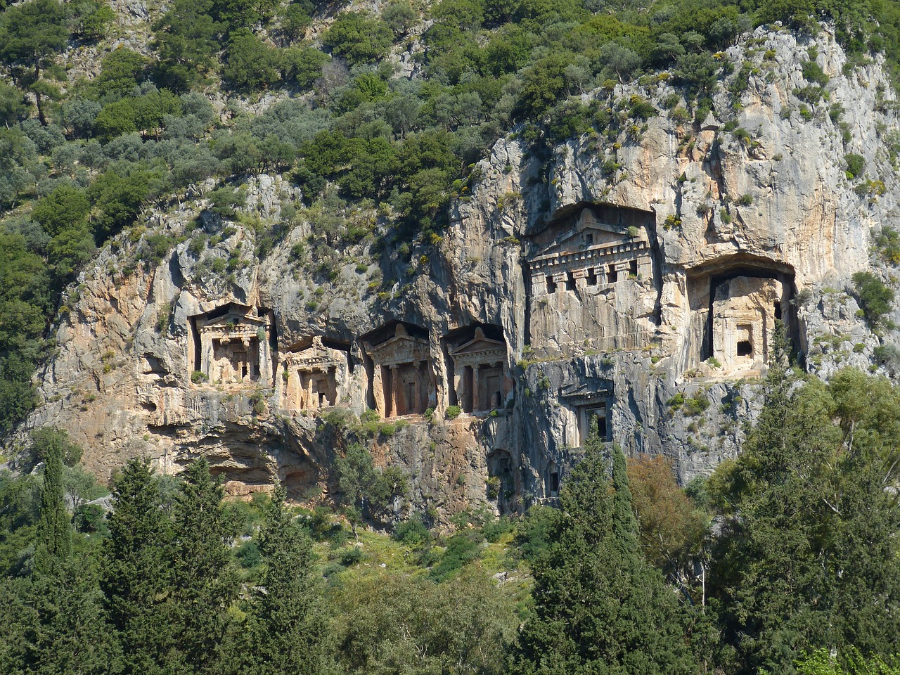 a group of buildings built into the side of a mountain, by Richard Carline, hurufiyya, turkey, temples, nice face, bay