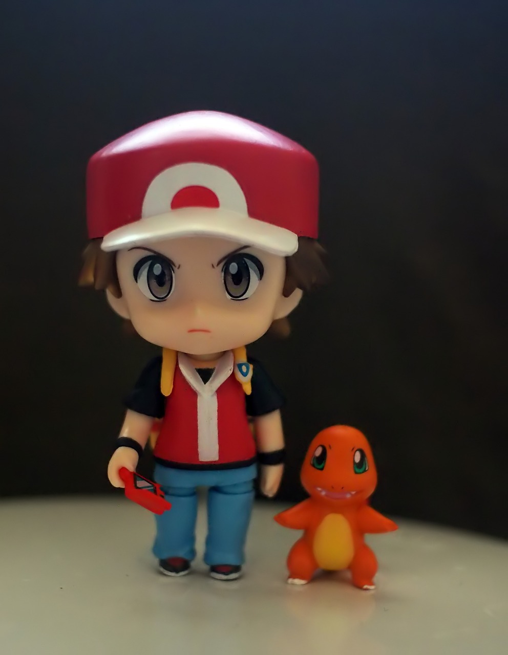 a close up of a toy on a table, inspired by Junpei Satoh, tumblr, charmander, nendroid, full body shot!!, wearing a red backwards cap