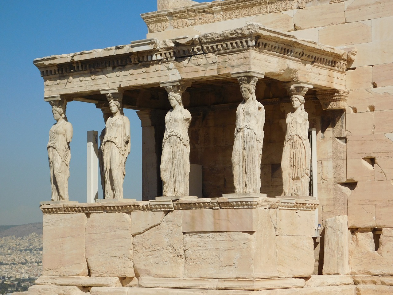 a group of statues sitting on top of a stone structure, a statue, neoclassicism, greek mask, stern like athena, classical style, not cropped