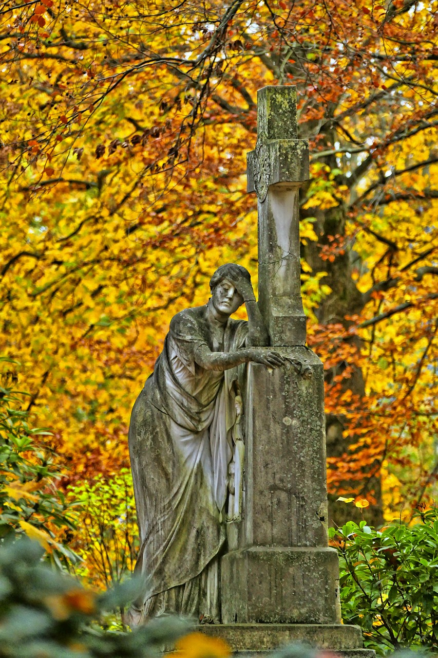 a statue of a woman leaning against a cross, a statue, by Dietmar Damerau, flickr, romanticism, autumn colors, tomb, with yellow cloths, detmold charles maurice