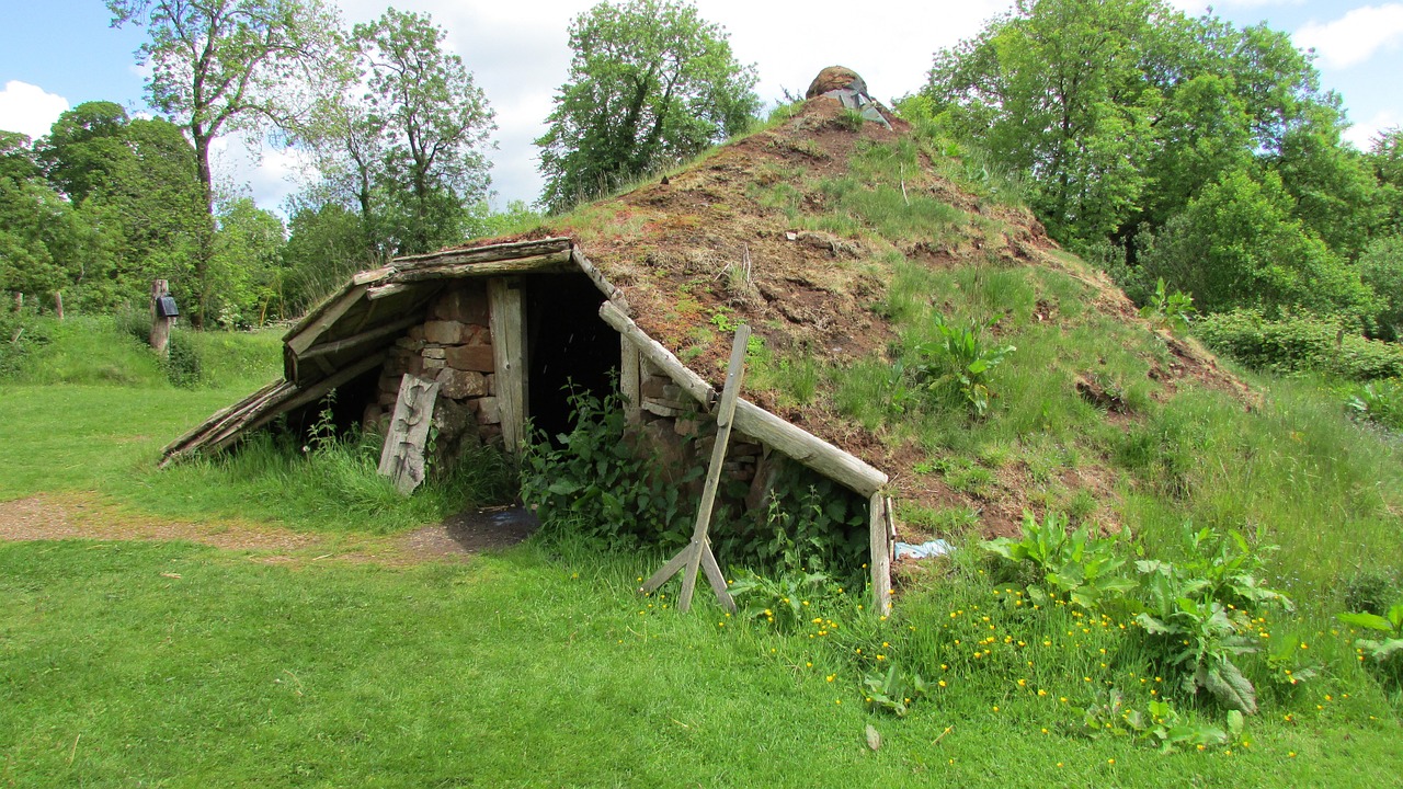 a pile of grass sitting on top of a lush green field, a photo, by Magdalene Bärens, renaissance, inside primitive hut, rock roof, brockholes, iso: 400