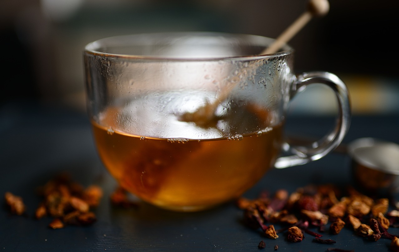 a cup of tea sitting on top of a table, a stock photo, by Frederik Vermehren, chili, honey, infused, close up shot