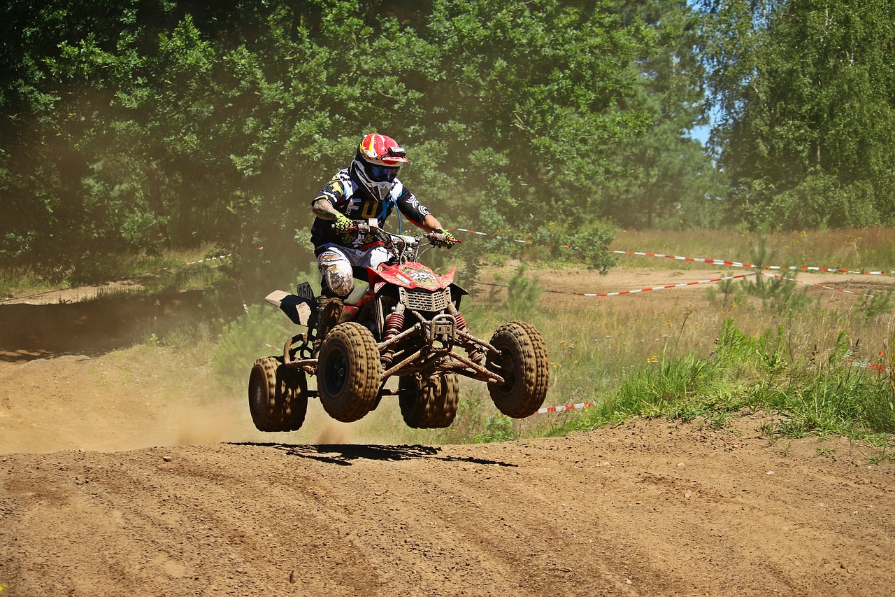 a man riding on the back of a dirt bike, a photo, by Aleksander Gierymski, shutterstock, in a race competition, buggy, high res photo, blog-photo