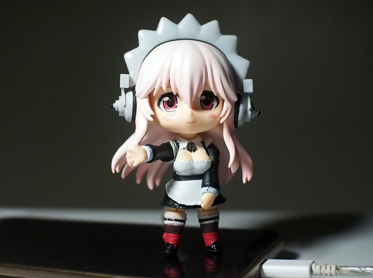 a close up of a doll on a cell phone, by Jin Homura, dj set, maid outfit, white-haired, micro pov