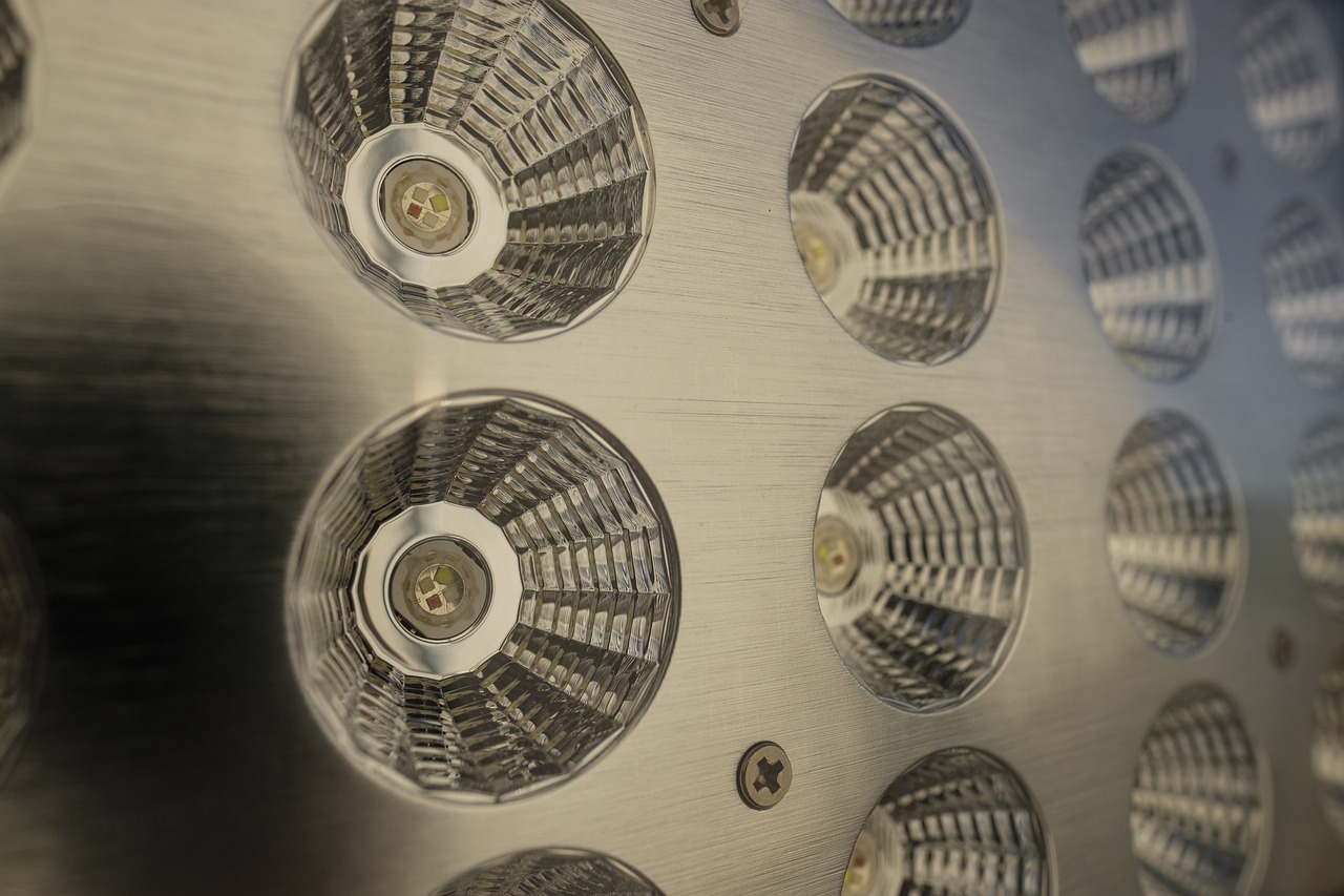 a bunch of lights that are on a wall, a macro photograph, photorealism, high detail product photo, volumetric search lights, stainless steel, fisheye lens photo