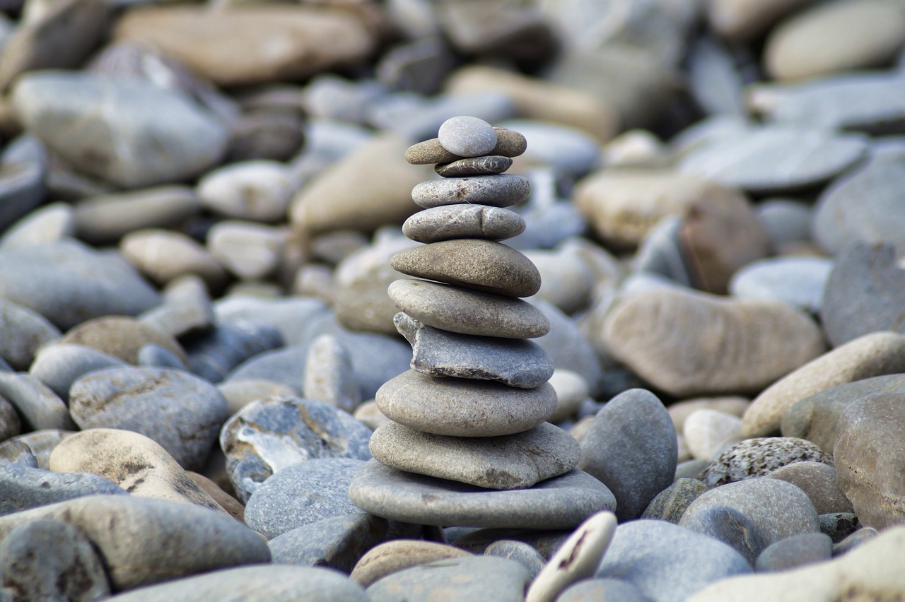 a stack of rocks sitting on top of a pile of rocks, a picture, inspired by Andy Goldsworthy, pexels, tower of babel, mobile wallpaper, istockphoto, small stature