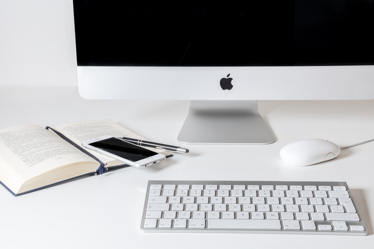 an apple computer sitting on top of a white desk, pexels, wikimedia, iphone, silver accessories, maintenance