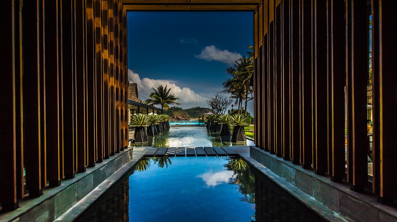 a reflection of the sky in a pool of water, by Reuben Tam, hallway landscape, resort, views to the ocean, f11