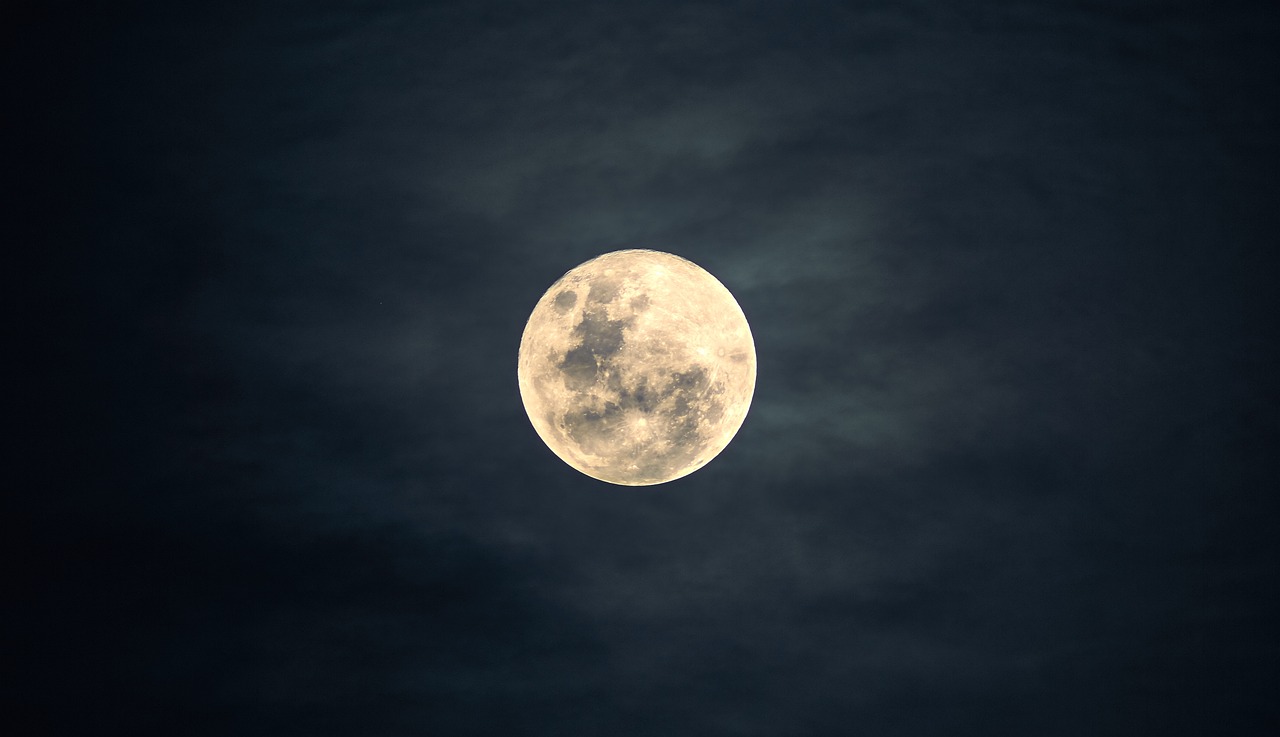 a full moon is seen in the dark sky, by Jan Rustem, pexels, overcast, stock photo, post processed, yellowish full moon