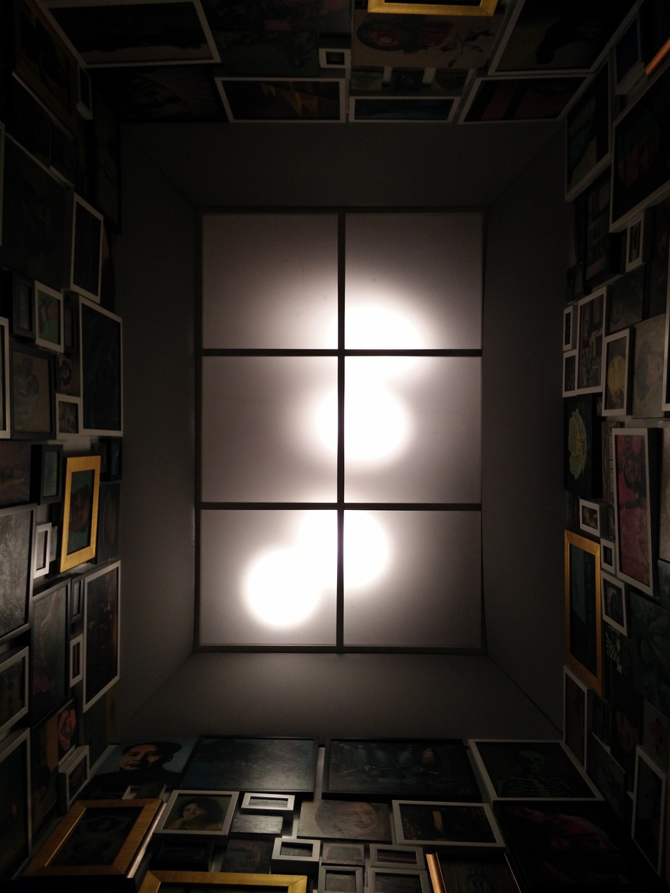 a room with a lot of pictures on the wall, a portrait, inspired by Leandro Erlich, flickr, light and space, solid cube of light, view from bottom to top, caustics lighting from above, squares