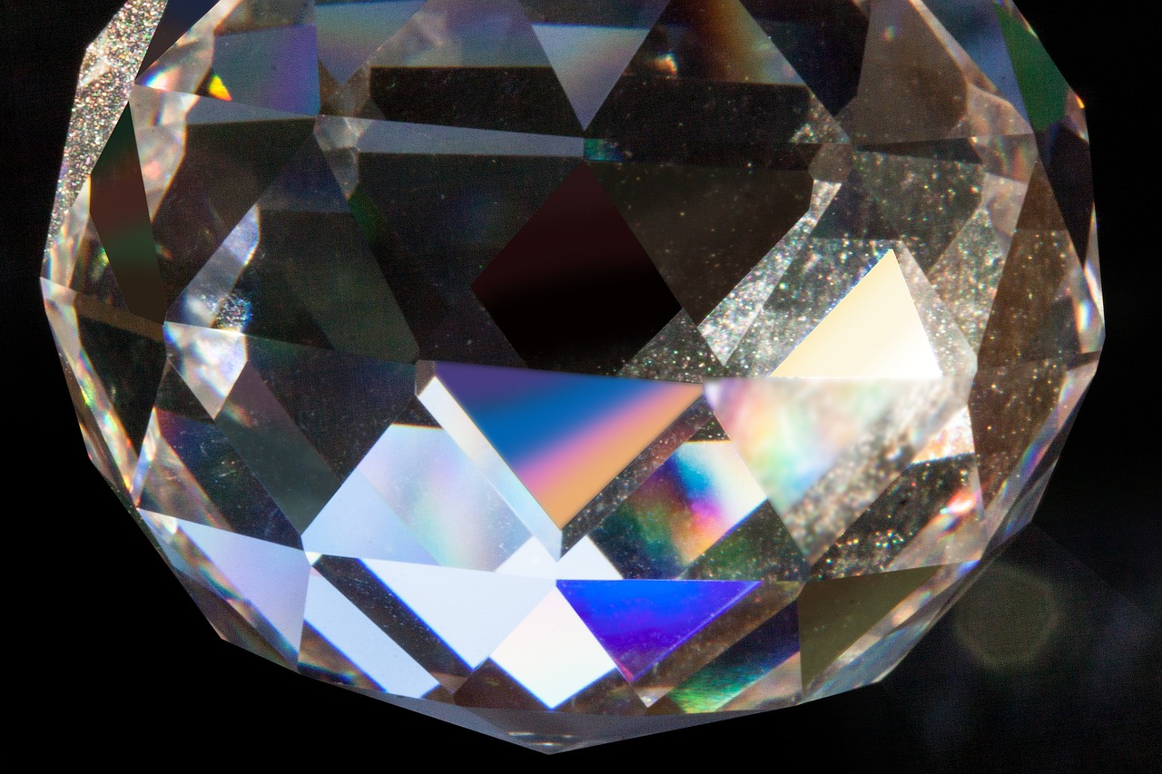 a close up of a crystal ball on a black surface, by Leonard Bahr, crystal cubism, rainbow diffraction, diamonds, sparkling in the sunlight, macro detail