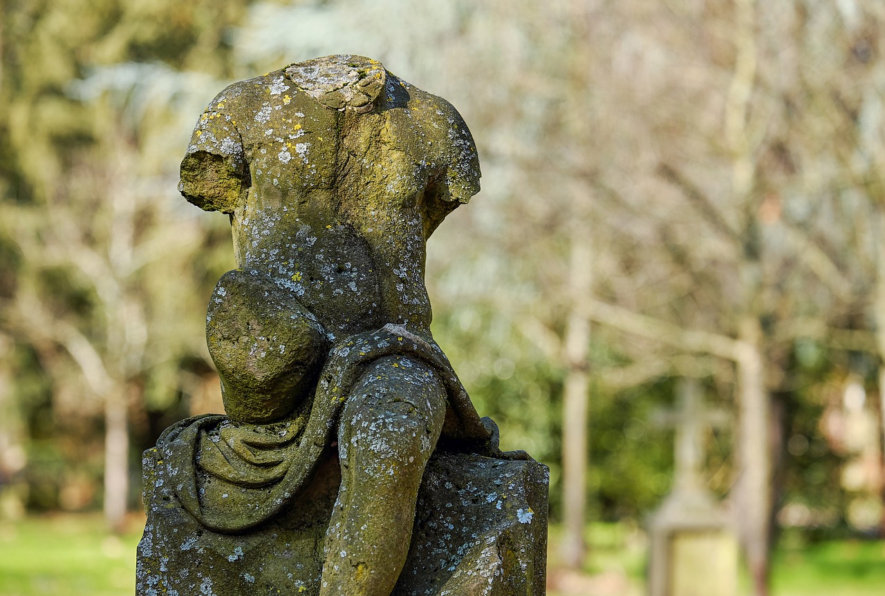 a stone statue in a park with trees in the background, a statue, by Julian Allen, rear view, very very well detailed image, torso, worn out