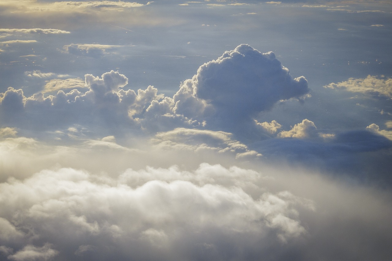 an airplane is flying high above the clouds, by Niko Henrichon, precisionism, cumulus, god - rays, bird\'s eye view, cumulus tattoos