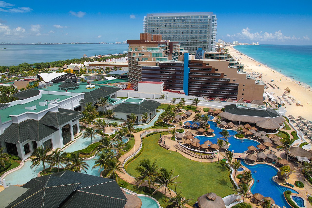 an aerial view of a resort in the middle of the ocean, happening, downtown mexico, next to a tropical pool, water park, yard