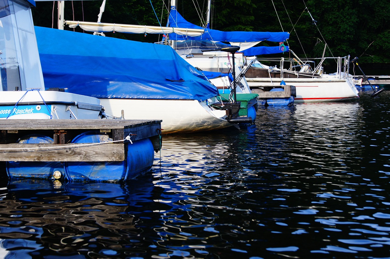 a number of boats in a body of water, a photo, by Jim Nelson, flickr, photorealism, blue drips, summer afternoon, shady look, covered!