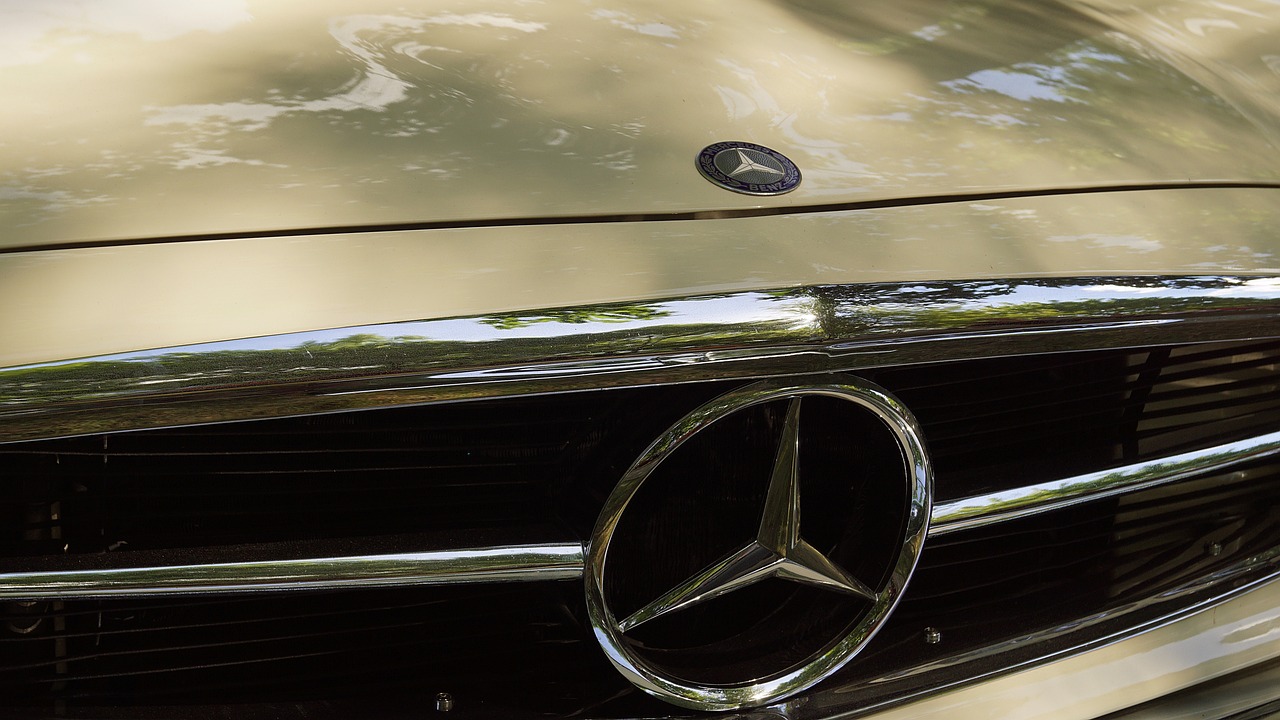 a close up of a mercedes logo on a car, a photo, by Thomas Häfner, pixabay, photorealism, retro 1 9 7 0 s kodachrome, liquid gold, portrait n - 9, facing front