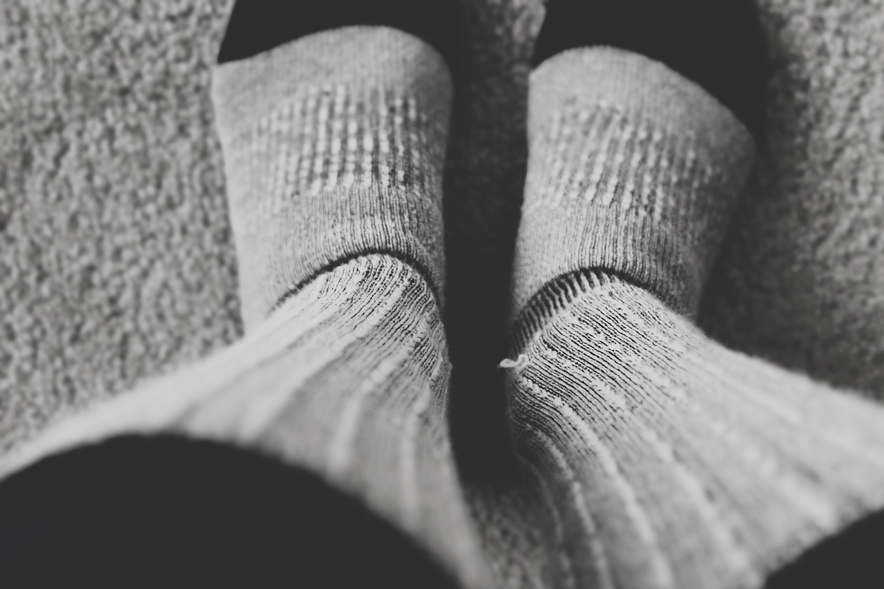 a person's feet in a pair of socks, a black and white photo, realism, iphone photo, full body extreme closeup, thick linings, my little everything