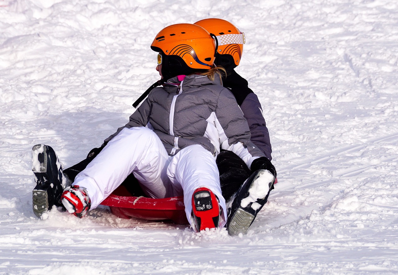 a couple of people riding a sled down a snow covered slope, by Arthur Sarkissian, shutterstock, fine art, wearing skate helmet, closeup photo, wallpaper - 1 0 2 4, kiss