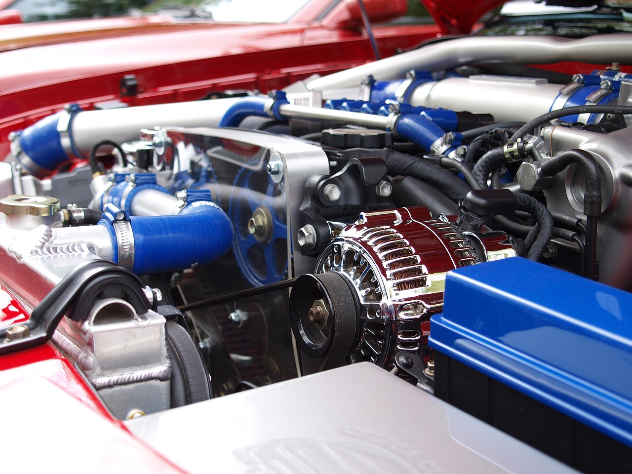 a close up of the engine of a car, blue and red color scheme, gleaming silver and rich colors, aftermarket parts, blog-photo