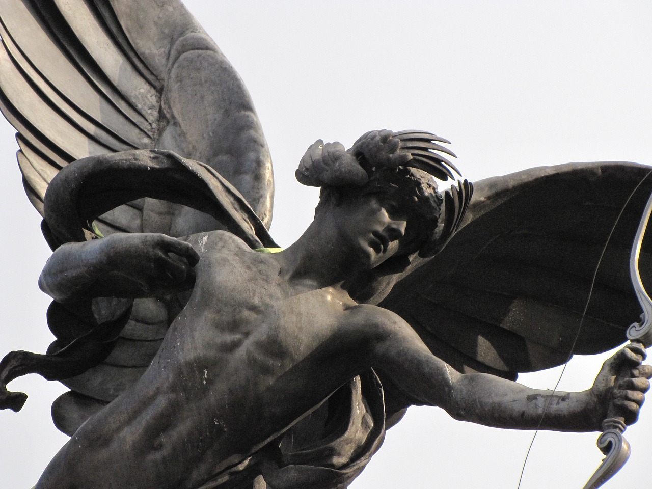 a statue of an angel holding a tennis racket, by Sir Jacob Epstein, trending on pixabay, black angel wings, hr giger muscles, side view close up of a gaunt, huge wings growing out of arms