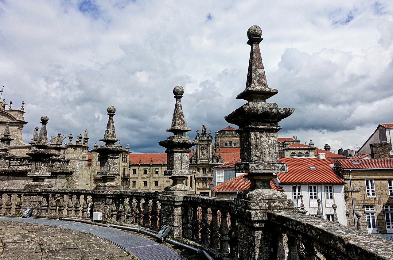 a view of a city from the top of a bridge, by Juan Giménez, pixabay, baroque, tall stone spires, gui guimaraes, stone roof, wikimedia commons