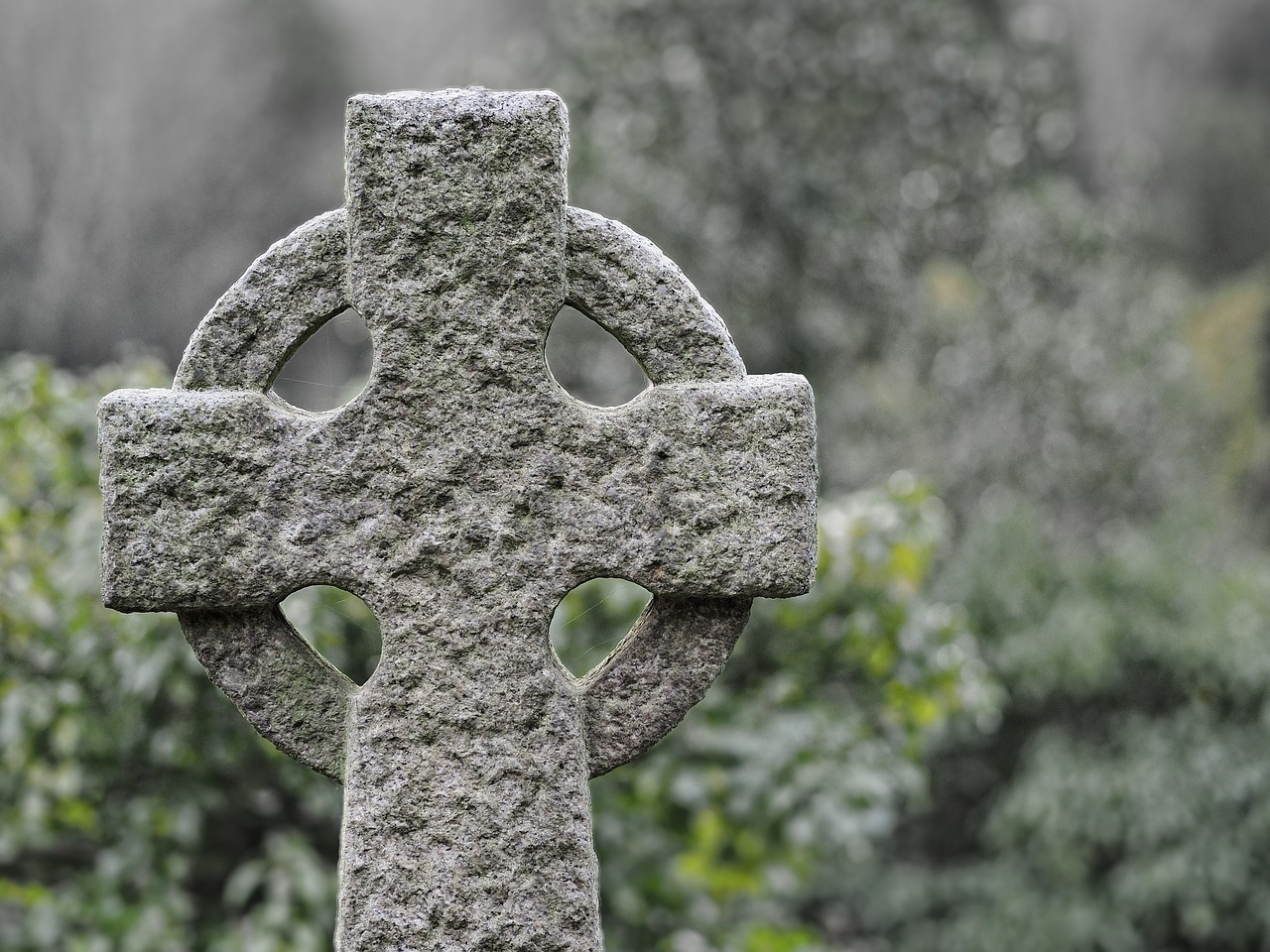 a stone cross sitting in the middle of a cemetery, celtic symbols, photograph credit: ap, half image, funeral