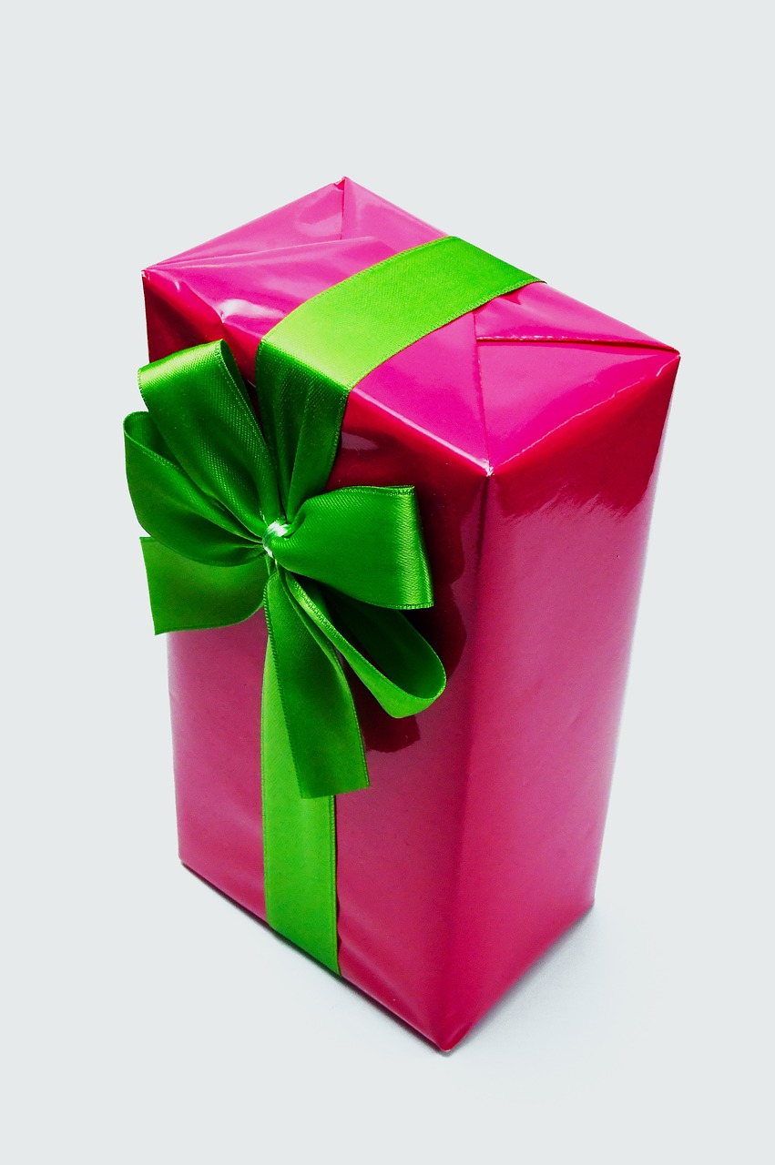 a pink gift box with a green bow, by Jan Rustem, pixabay, glossy finish, vinyl, karim rashid, set against a white background