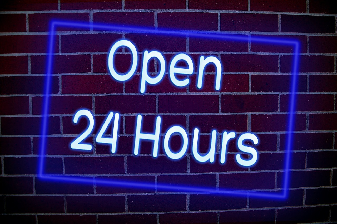 a neon sign reading open 24 hours on a brick wall, a stock photo, by Josh Bayer, shutterstock, fine art, with glowing blue lights, 2 0 2 2 photo, tattoo parlor photo, 28mm