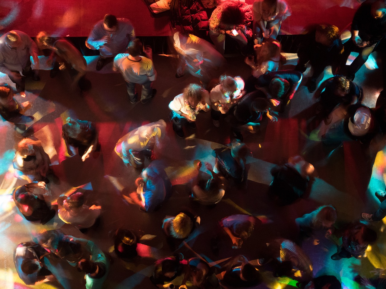 a crowd of people standing around each other, a tilt shift photo, by Jon Coffelt, nightclub dancing inspired, top-down shot, psychedelic lighting, scientific photo